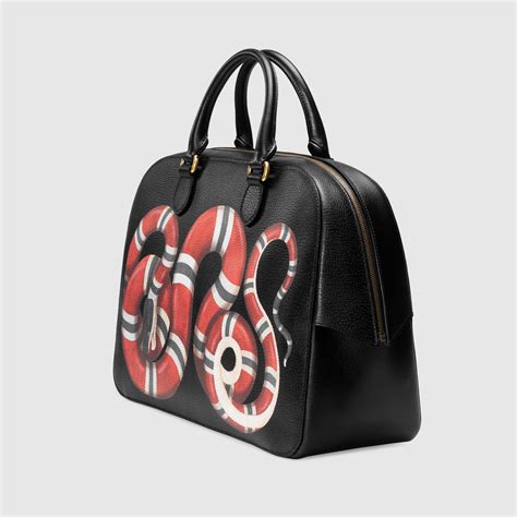 gucci snake print duffle bag.